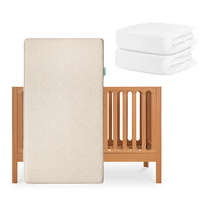 The Newton Baby Galileo Crib, Original Crib Mattress, and two folded organic cotton sheets are displayed together against a plain white background. skip