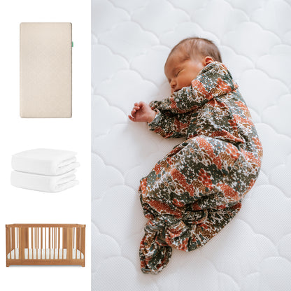 A newborn in a floral sleeper lies on a white crib mattress with a breathable organic cotton sheet. To the left are images of Newton Baby's Nest Convertible Crib, Original Mattress, and two white sheets. 111-8420-CST-1000-SAN-WNW