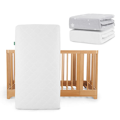 The Newton Baby Nest Convertible Crib with an Original Mattress is shown, next to two breathable organic cotton crib sheets—one gray with white stars and one solid white—from the Nest Convertible Crib, Original Mattress, & Sheets set.