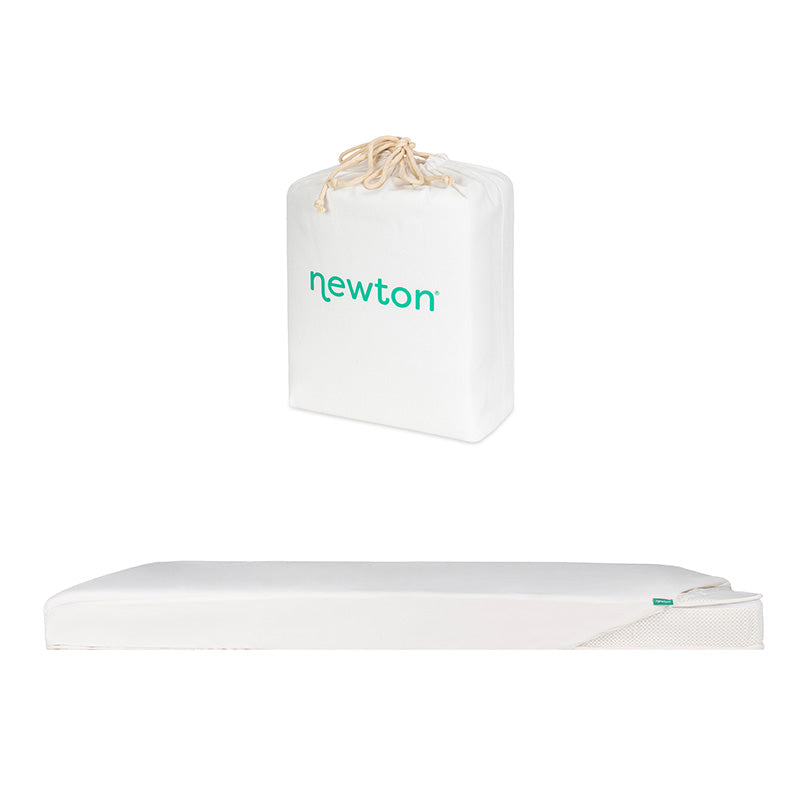 A white crib mattress with a partially unzipped cover and a matching white drawstring storage bag, both featuring Newton Baby branding, are shown on a white background. Product: Bundle 1 BFCM by Newton Baby. SKIP