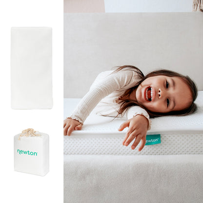 A smiling child lies on a Newton Baby Bundle 1 BFCM crib mattress with a Newton label. To the left, images display the mattress rolled in a white bag and unrolled flat.