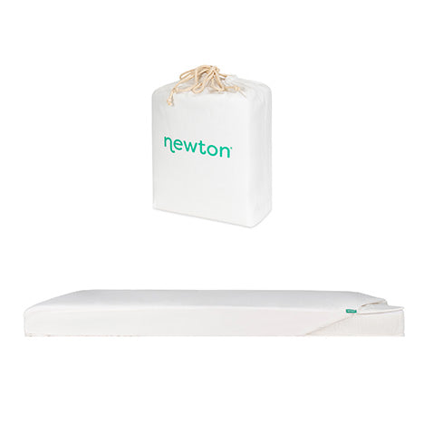 A white Newton Baby Bundle 1 BFCM crib mattress with a removable cover is shown lying flat, with its carrying/storage bag placed above it.