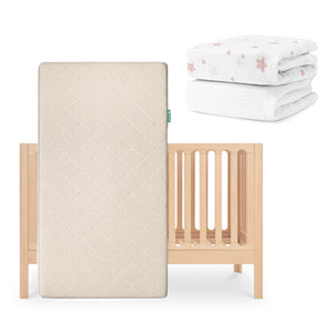 The Newton Baby Galileo Crib, Original Crib Mattress stood upright in front, and folded organic cotton Sheets with pink stars shown above and to the right. skip
