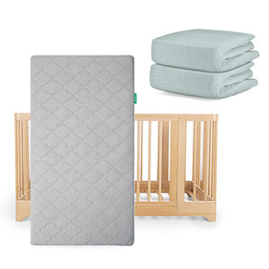 The Newton Baby Nest Convertible Crib with the Original Mattress has two light green fitted sheets from the Nest Sleep Bundle stacked nearby.