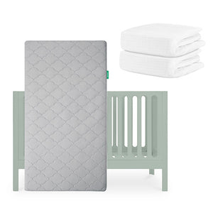 A light gray Newton Baby Galileo Crib with an Original Crib Mattress stands upright, while two folded Breathable Organic Cotton Sheets are stacked in the upper right corner. skip