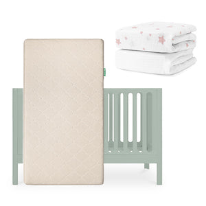 The Newton Baby Galileo Crib, Original Crib Mattress, and two crib sheets—one plain white and one organic cotton with pink stars—are displayed above. skip