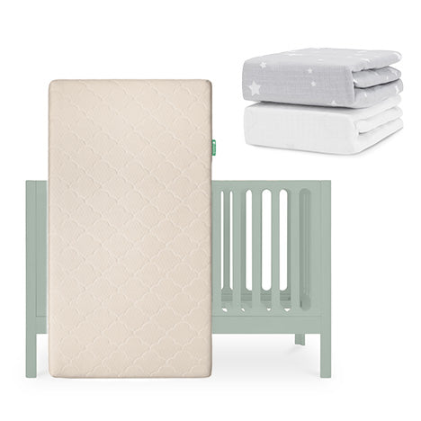 A light green Newton Baby Galileo Crib with an Original Crib Mattress in front. Above and right are two folded sheets: one gray with white stars and one plain white Breathable Organic Cotton Sheet. skip
