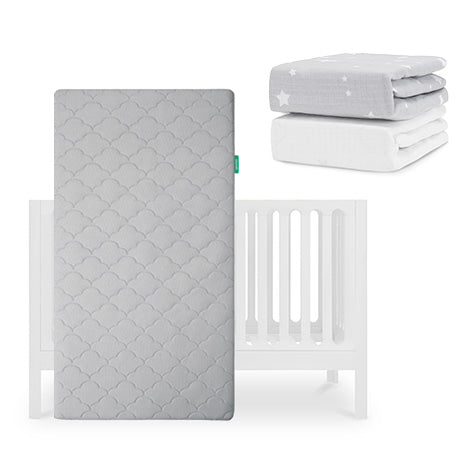A Newton Baby Galileo Crib, Original Crib Mattress, and two sheets—one light gray with stars and one plain white breathable organic cotton—are displayed together. skip