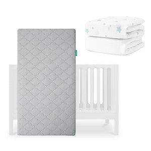 The Newton Baby Galileo Crib, Original Crib Mattress, and Sheets are shown: a gray breathable mattress stands upright by the crib, with two folded sheets—one organic cotton and one white with blue stars—in the top right corner. skip