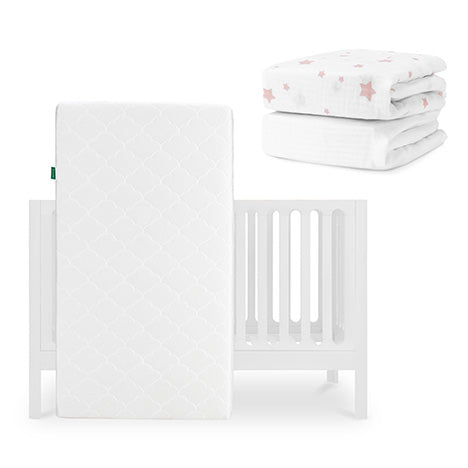 The Newton Baby Galileo Crib is paired with an Original Crib Mattress, a folded white sheet with pink stars, and a plain white sheet from the Sheets set. skip