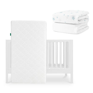 The Newton Baby Galileo Crib is shown with the Original Crib Mattress propped against it, plus two folded white crib sheets with blue star patterns—including a Breathable Organic Cotton Sheet—placed above to the right. skip