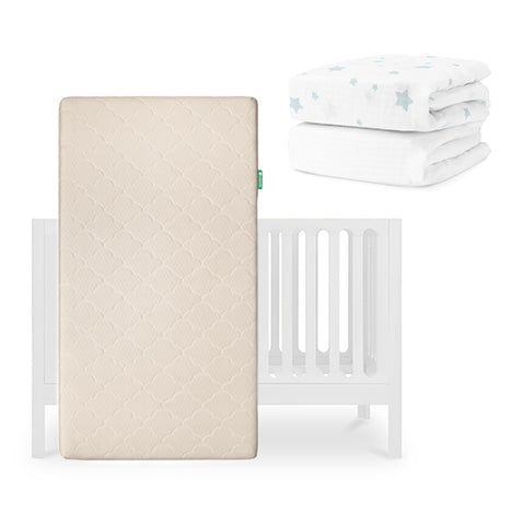 The Newton Baby Galileo Crib, Original Crib Mattress, and two sheets—a white one and one with blue stars—are shown together, ideal for pairing with a Breathable Organic Cotton Sheet. skip