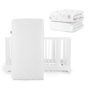 The Newton Baby Nest Convertible Crib, Original Mattress, and Sheets set features a white crib and mattress, plus two folded sheets—one with pink stars, one plain white—all designed to provide comfort for your baby.