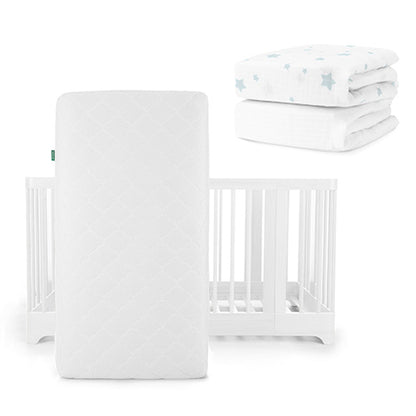 A white Newton Baby Original Mattress stands vertically before a Nest Convertible Crib, with breathable organic cotton sheets featuring light blue stars folded in the background.