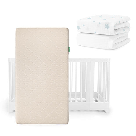 A beige Newton Baby Original Mattress stands upright before a white Nest Convertible Crib, with two folded white sheets featuring blue star prints placed above and to the right. All products are from the Nest Convertible Crib, Original Mattress, & Sheets collection.