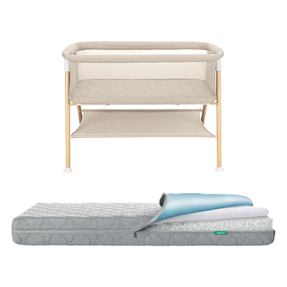 The Newton Baby Essential Bassinet + Waterproof Mattress features wooden legs, a storage shelf, and a gray breathable quilted mattress partially covered by a blue and white waterproof protector.