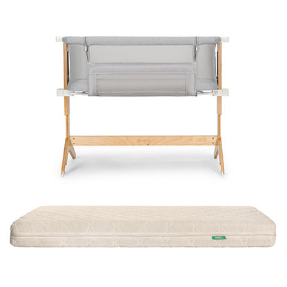 The Newton Baby Bassinet & Bedside Sleeper with light gray mesh is paired with the Original Crib Mattress, which features a cream-colored, patterned cover.