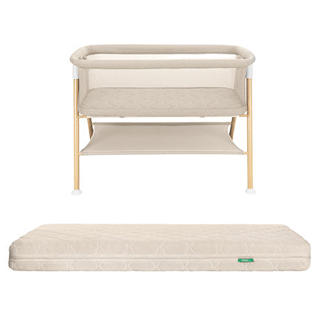 The Newton Baby Essential Bassinet + Original Crib Mattress set features a beige bassinet with light wooden legs, mesh sides for airflow, a shelf underneath, and a matching breathable mattress in color and texture.
