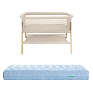 The Newton Baby Essential Bassinet with mesh sides and storage shelf stands behind the Original Crib Mattress in light blue, quilted, and breathable.