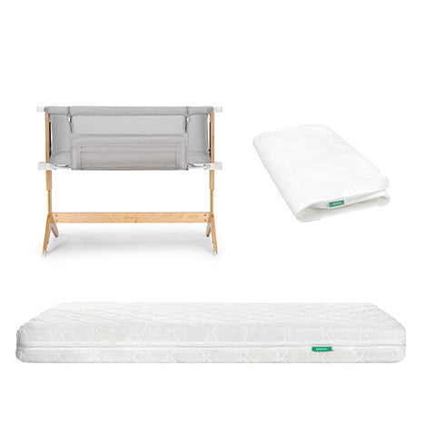 The Newton Baby Bundle 6 BFCM includes a wooden bassinet with a gray fabric side, a folded white fitted sheet, and a subtly patterned white mattress, all displayed on a white background.