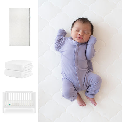 A baby sleeps in a lavender onesie on the Newton Baby Galileo Crib with the Original Crib Mattress & Sheets. To the left are images of the convertible crib, two organic cotton sheets, and a white barred crib. 111-8420-WHT-1000-WHT-WNW
