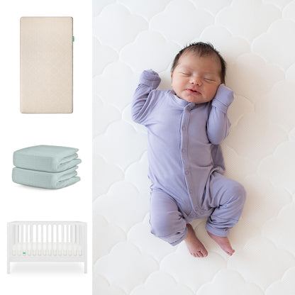 A newborn in a purple onesie sleeps on the Newton Baby Galileo Crib with the Original Crib Mattress and organic cotton sheets. Nearby are images of the convertible crib, folded mint-green sheets, and a white crib. 111-8420-WHT-1000-SAN-SNS
