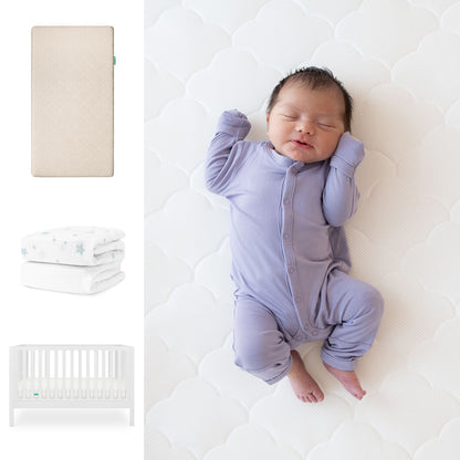 A baby in a lavender onesie sleeps on the Newton Baby Galileo Crib with the Original Crib Mattress & organic cotton sheets. To the left are images of the beige mattress, a star-print blanket, and the convertible crib. 111-8420-WHT-1000-SAN-SDW
