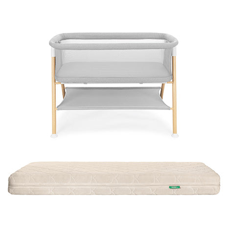 The Newton Baby Essential Bassinet with light wood legs and gray mesh frame is paired with the Original Crib Mattress, both displayed on a plain white background.