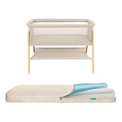 The Newton Baby Essential Bassinet + Waterproof Mattress in beige with gold legs is shown above its matching breathable mattress, unzipped to display the blue foam layer and white cover inside.