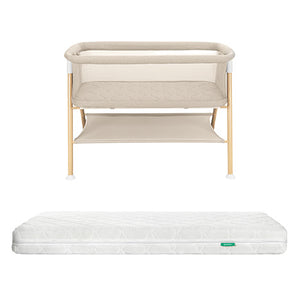 The Newton Baby Essential Bassinet with wooden legs and lower storage shelf is paired with the Original Crib Mattress, displayed on a plain white background.