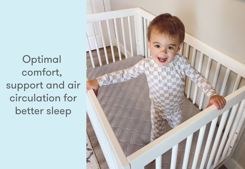 A happy toddler standing in a crib with text saying "Optimal comfort, support and air circulation for better sleep."