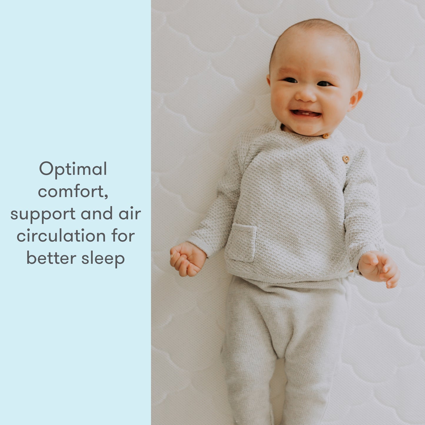 A smiling baby lying on a light-patterned background, wearing a textured light gray outfit, with the text "Optimal comfort, support, and air circulation for better sleep" on the left side.