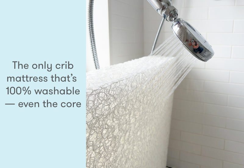 A crib mattress being washed under a shower, with text stating "The only crib mattress that’s 100% washable — even the core."