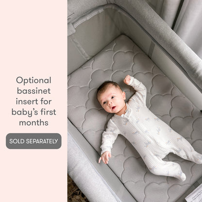baby lying in zip-in bassinet insert, with text, "optional bassinet insert for baby's first months, sold separately"
