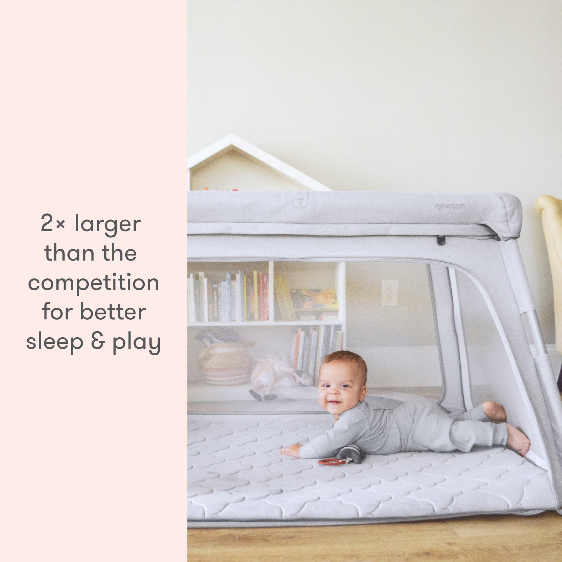 baby lying on floor mattress in newton travel crib and play yard, with text "2x larger than the competition for better sleep and play"
