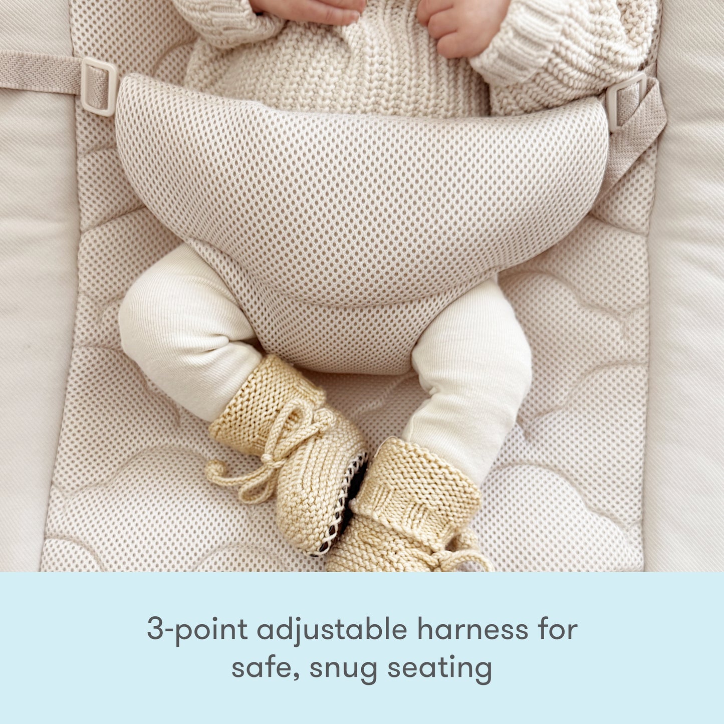 A baby wearing a knit sweater and booties sits in the Newton Baby Rocker, featuring a breathable seat cover and 3-point adjustable harness. Text below reads: 3-point adjustable harness for safe, snug seating.
