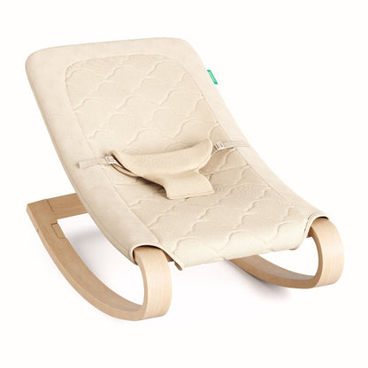 The Newton Baby Rocker features a quilted, breathable light beige seat cover and wooden curved legs, plus a simple adjustable harness for added safety.