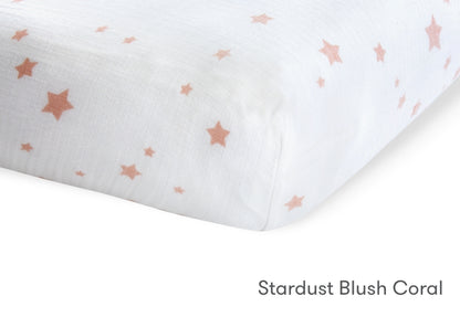 Close-up of a Newton Baby crib mattress in Stardust Blush Coral pattern with small pink stars. 999-3020-PSW 999-3520-PSW