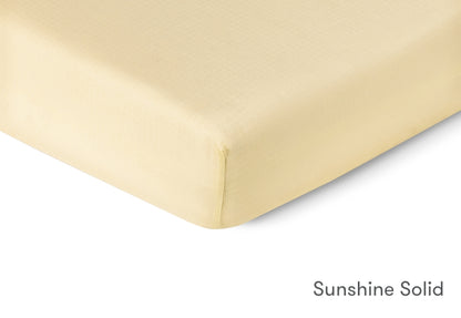 Close-up of a sunshine solid-colored sheet by Newton Baby.