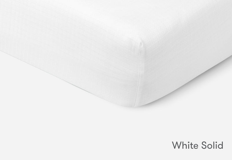 Close-up of a white solid Newton baby mattress. 999-3020-WNW 999-3520-WNW