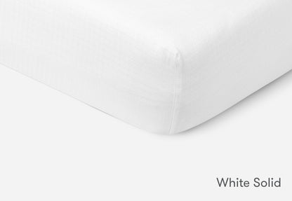 Close-up of a white solid Newton baby mattress. 999-3020-WNW 999-3520-WNW
