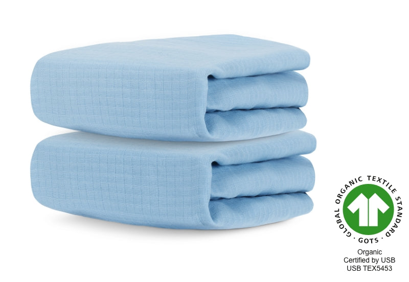 Two folded light blue organic crib sheets with a 'Global Organic Textile Standard (GOTS) - Certified by USB USB TEX5453' logo. 999-3020-BNB 999-3520-BNB