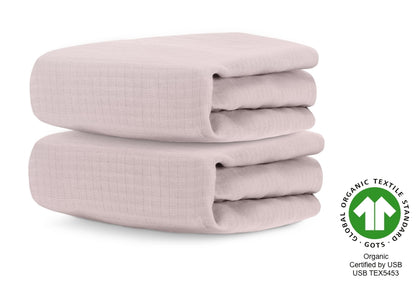 Two folded organic cotton baby blankets in sunset pink, certified by GOTS with certification number USB TEX5453. 999-3020-PNP 999-3520-PNP