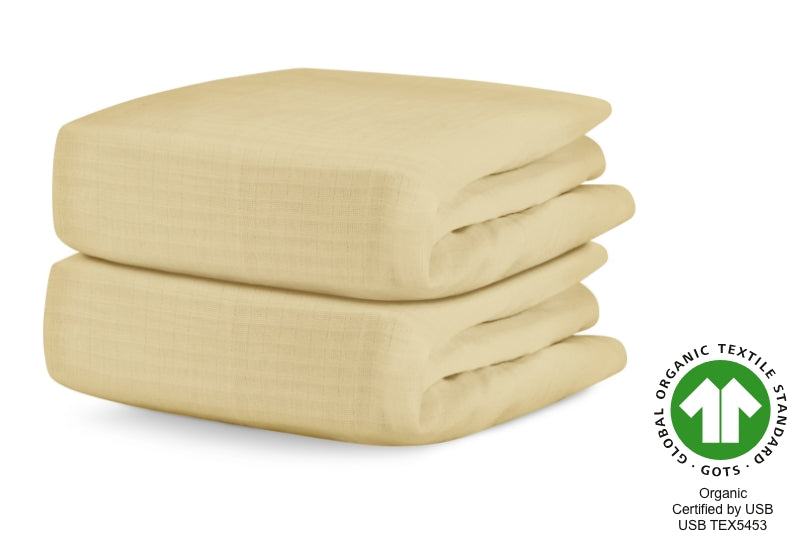 A stack of two pale yellow organic cotton baby blankets, labeled with "Global Organic Textile Standard, Organic Certified by USB, USB TEX5453."