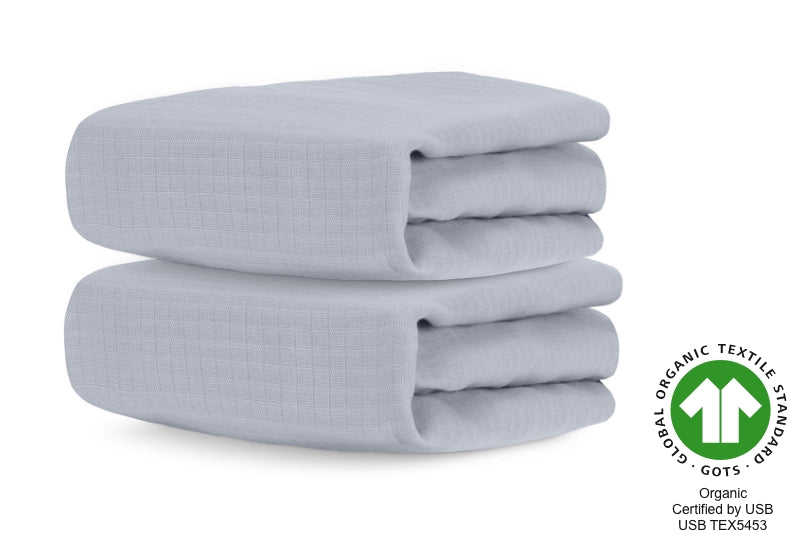 Two neatly folded, twilight grey organic cotton baby blankets with GOTS (Global Organic Textile Standard) certification logo and text "Organic Certified by USB USB TEX5453". 999-3020-GNG 999-3520-GNG
