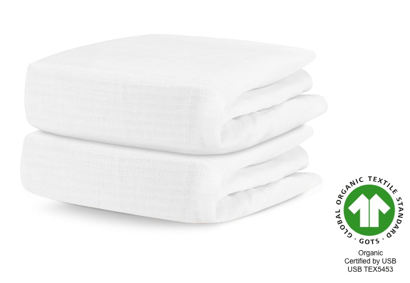 Two neatly stacked organic white baby blankets with a certification logo for Organic Textile Standard GOTS, certified by USB TEXS45. 999-3020-WNW 999-3520-WNW