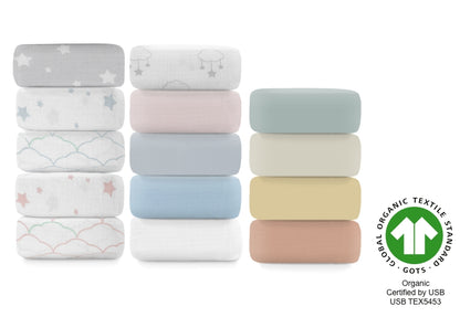 A stack of assorted sheets in various pastel colors and patterns, including stars and clouds, certified by GOTS and USB TEX5453.