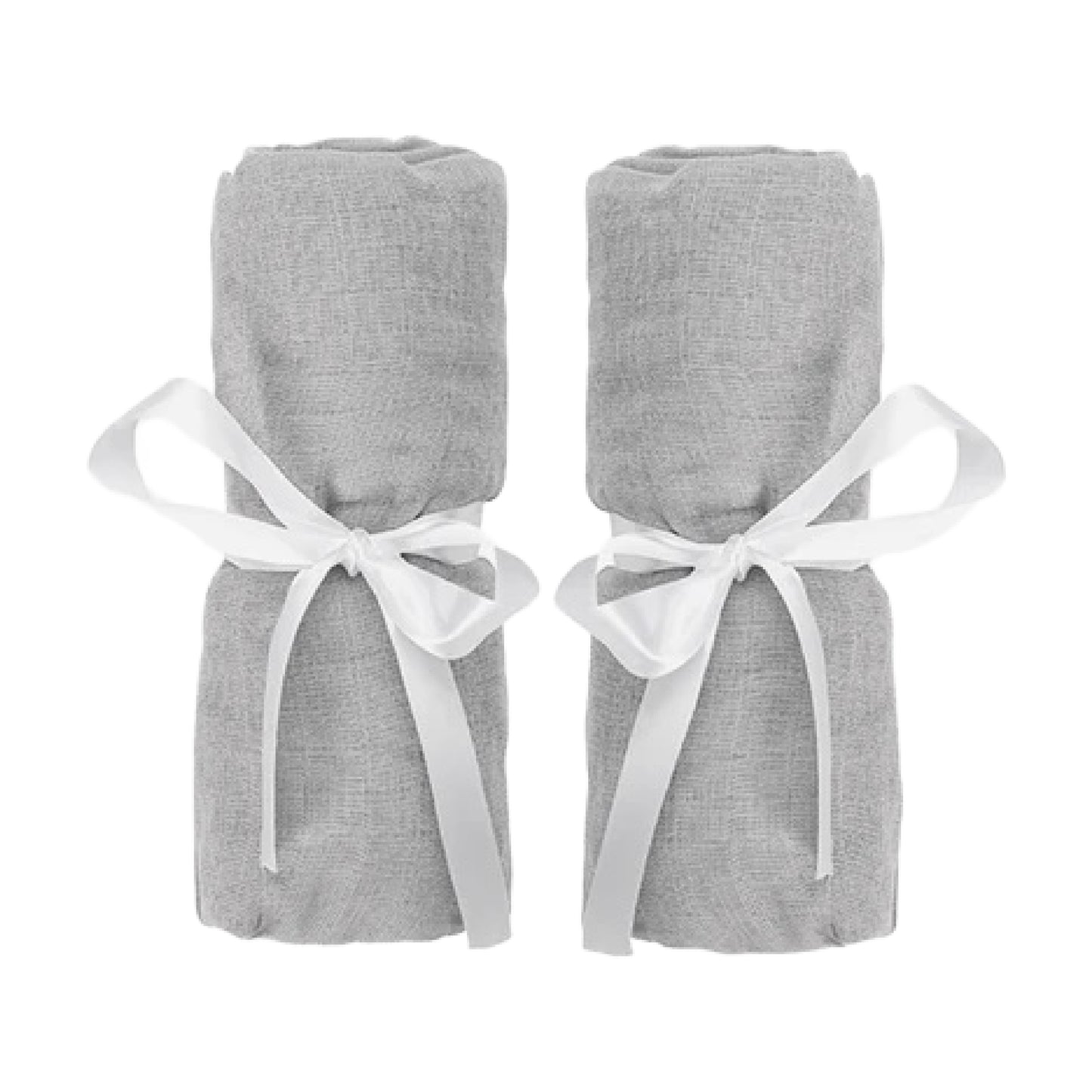 Two rolled-up Newton Baby Compact Travel Crib Sheets in light gray cotton muslin, each tied with a white ribbon bow, are placed side by side against a white background.