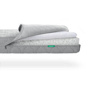 Cross-section of a Newton Baby Crib Mattress showing layers including a fibrous, washable inner core. skip
