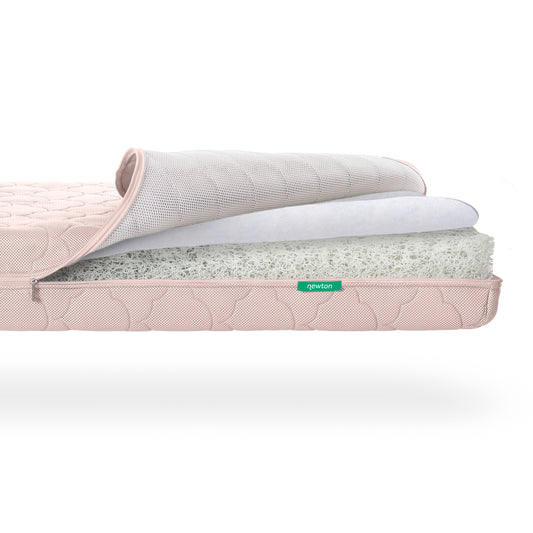 Cross-section view of a Newton Baby Crib Mattress showing its layered mesh and foam core construction. skip